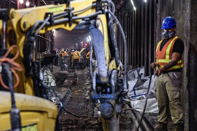 Construction workers from the MTA in the tracks with equipment